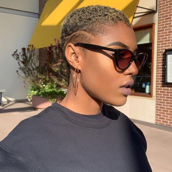 a lady rocking a low cut with sunglasses