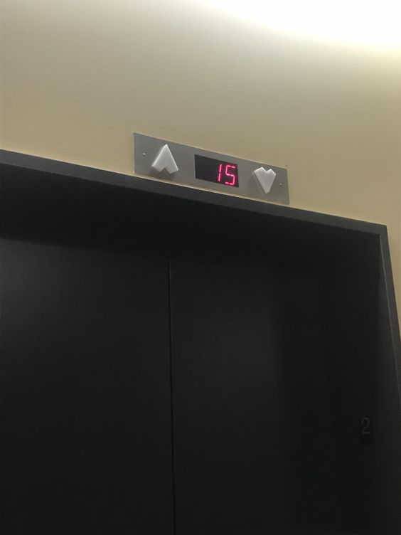 The elevator signals at this hospital are shaped like hearts