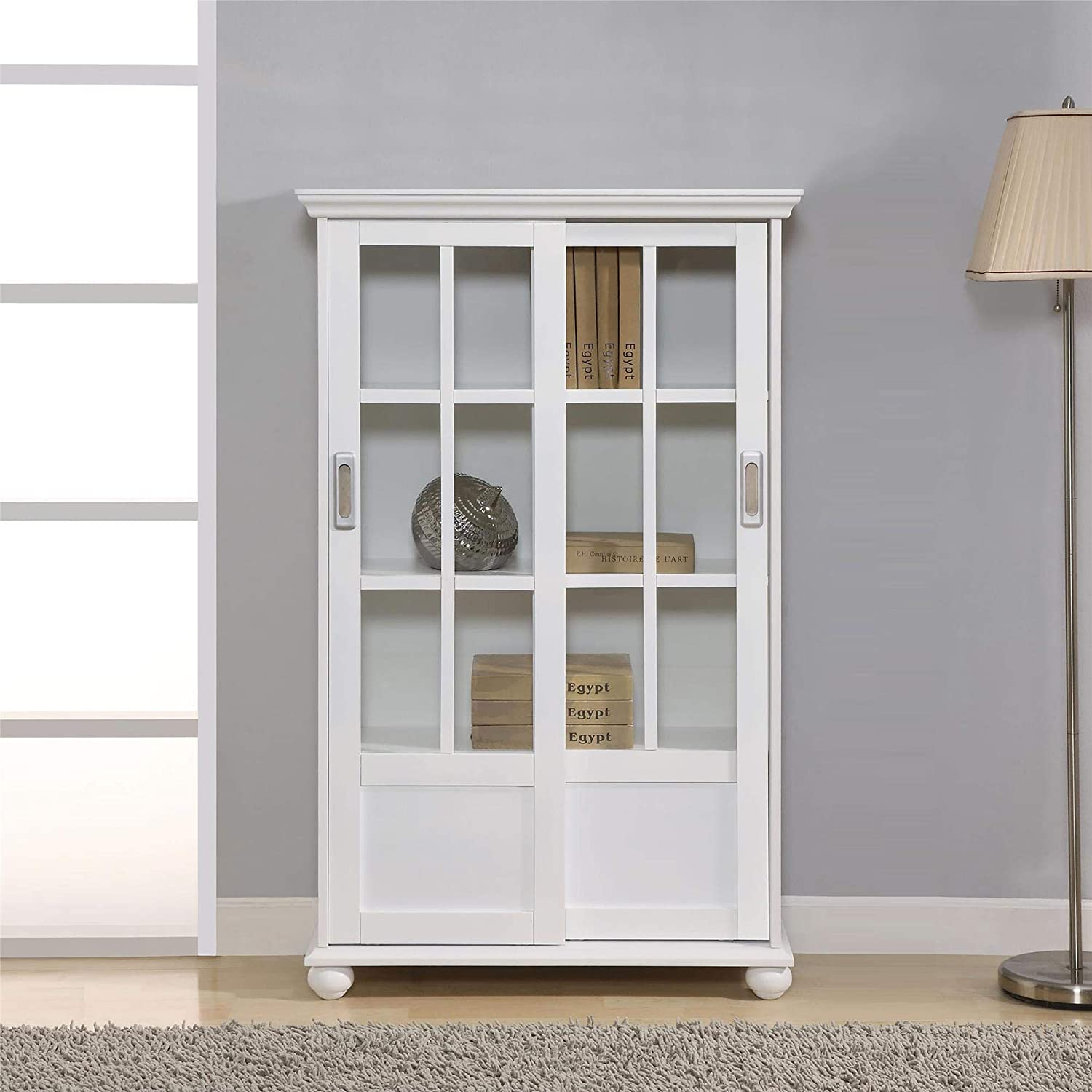 A bookcase with a glass door is among the best choices if you are proud of your personal library and want to showcase it like artworks. In nowadays’ market, Altra Aaron Lane Bookcase with Sliding Glass Doors is the best of its kind.
