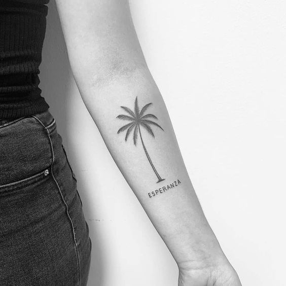 A beautiful view of a girl rocking the palm tree tattoo