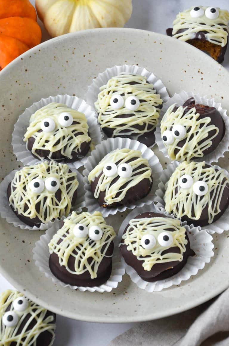 Healthy Halloween desserts - Mummy truffles, displayed on a white plate.