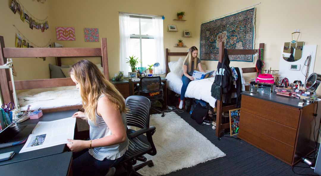A photo of an Emory University dormitory unit with two girls reading medical notes