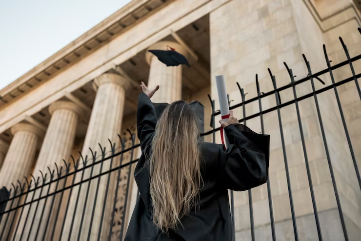 Graduate tossing her trencher in celebration.