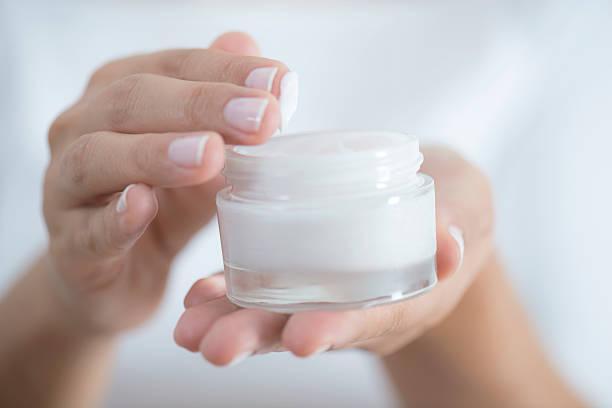 Moisturizer Female hand holding moisturizer in hand, horiztonal dry nails stock pictures, royalty-free photos & images