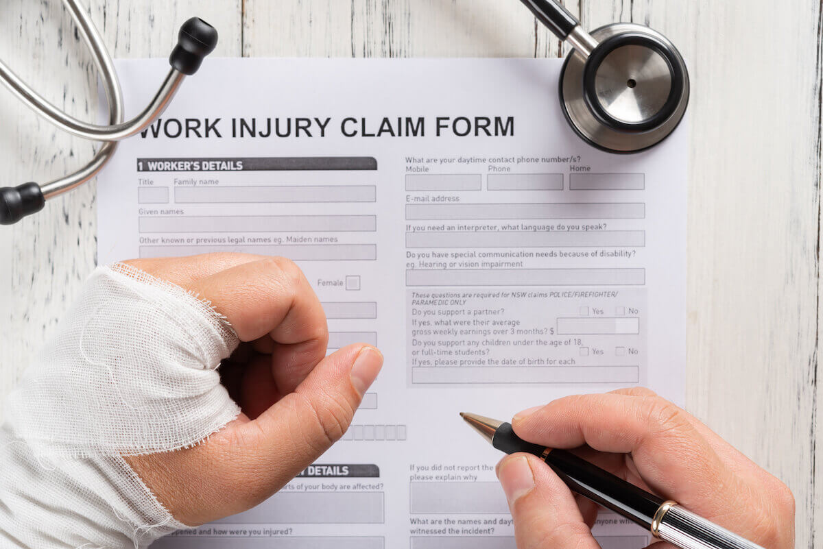 Person filling out a work injury form