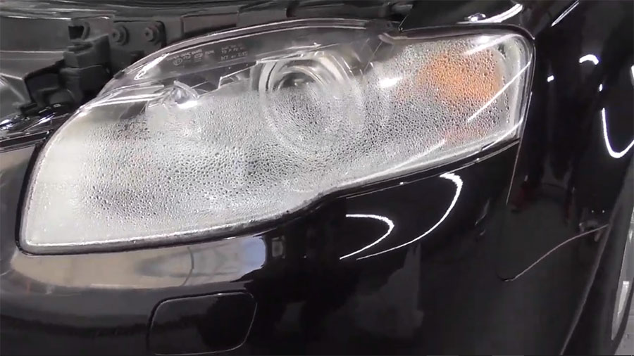 Begin by drying everything within. Then, either obtain a hot glue machine and apply a new thin layer around the whole unit, or, if you're in luck, buy another headlamp gasket from an auto parts retailer.