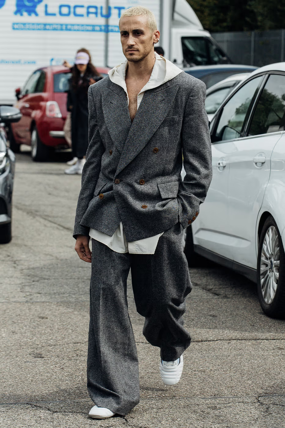 Guy wears suit for the street style moment at Milan