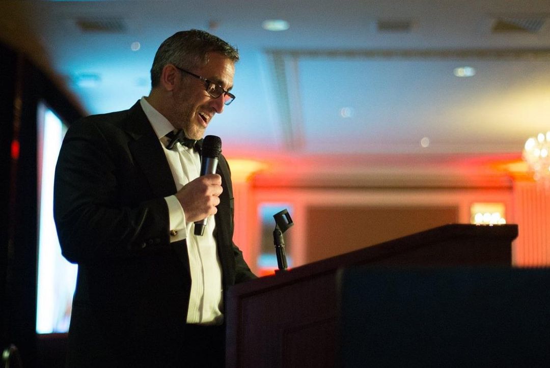 A Master of Ceremonies speaks at an Events By Design non-profit event.
