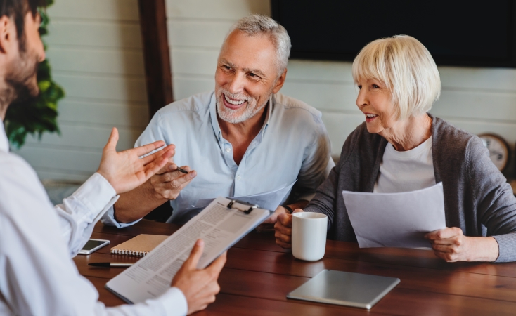 older couple discussing storm insurance with an agent