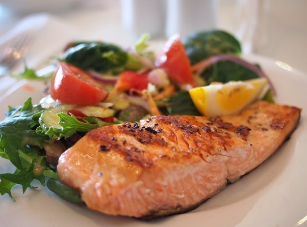 Mediterranean dish with salmon and salad - Smart Tips to Eat Healthy on a Budget