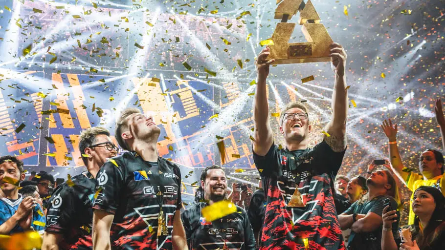 Esports team celebrating with trophy and confetti