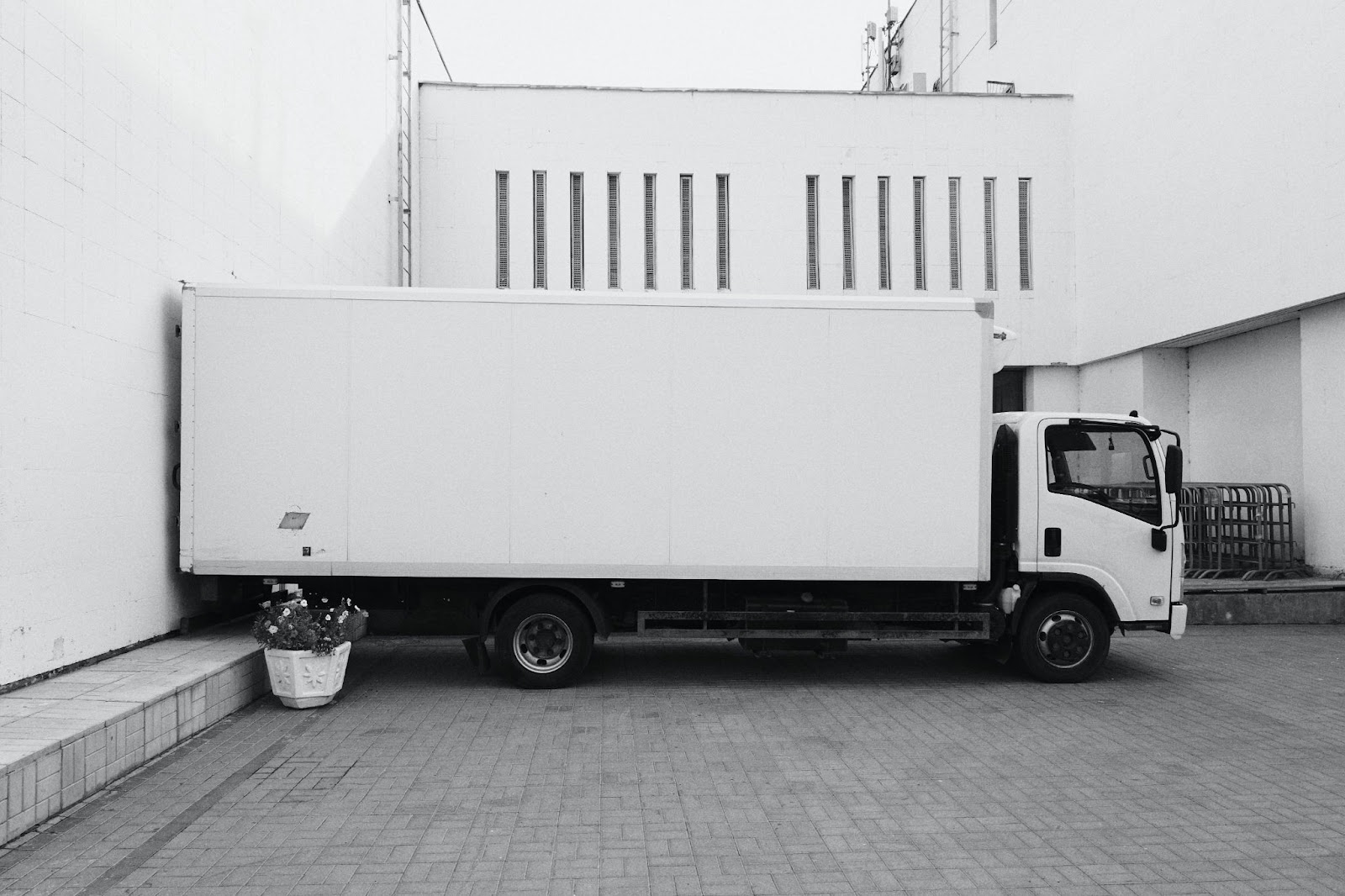 A white box truck against a white wall