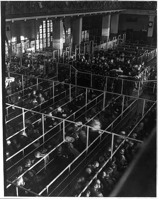 Immigrants waiting in "pens"