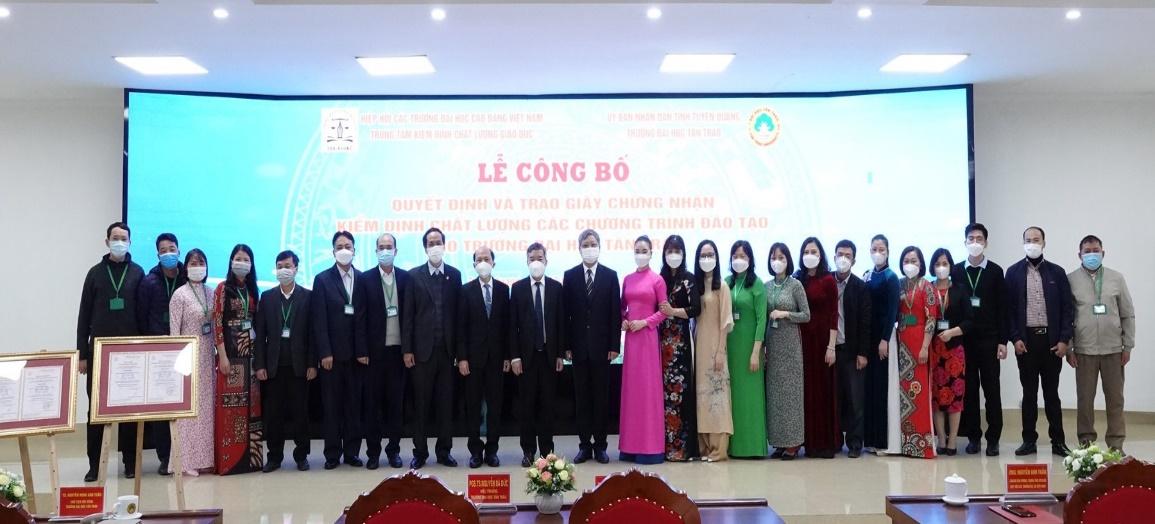A group of people standing in front of a large screen

Description automatically generated with medium confidence