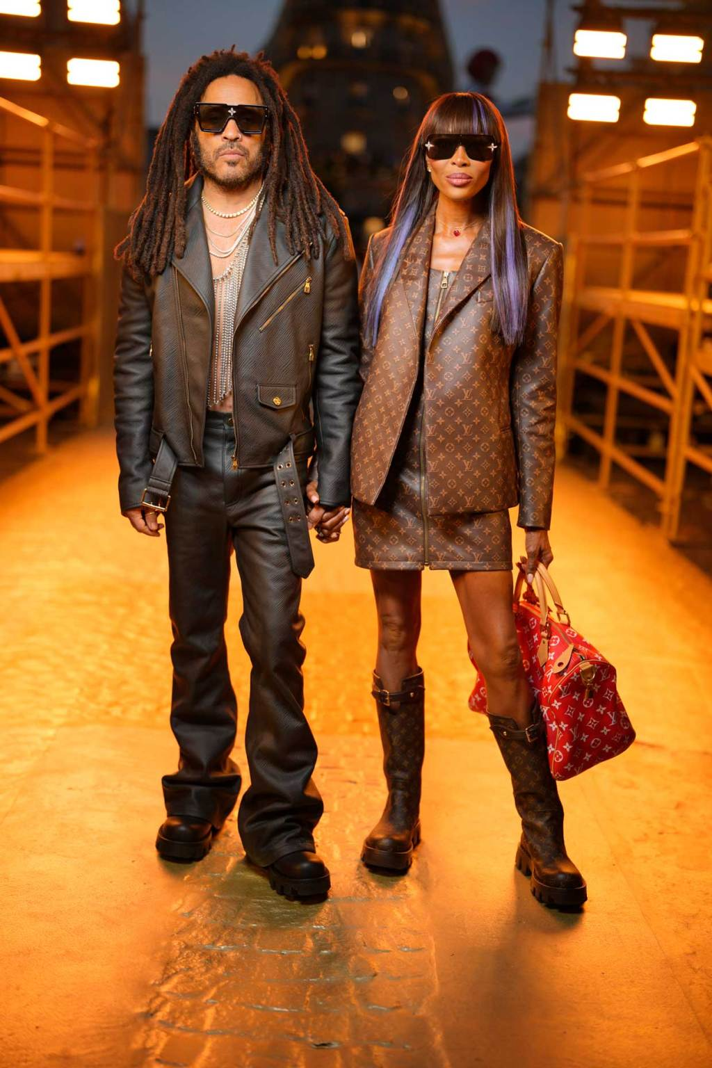 Paris Fashion Week Menswear Spring/Summer 2024: Naomi Campbell rocks  a leather jacket two-piece standing next to a stylish guy