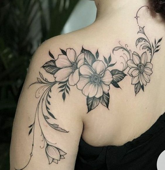 lady wearing flower tattoo on her shoulder blade