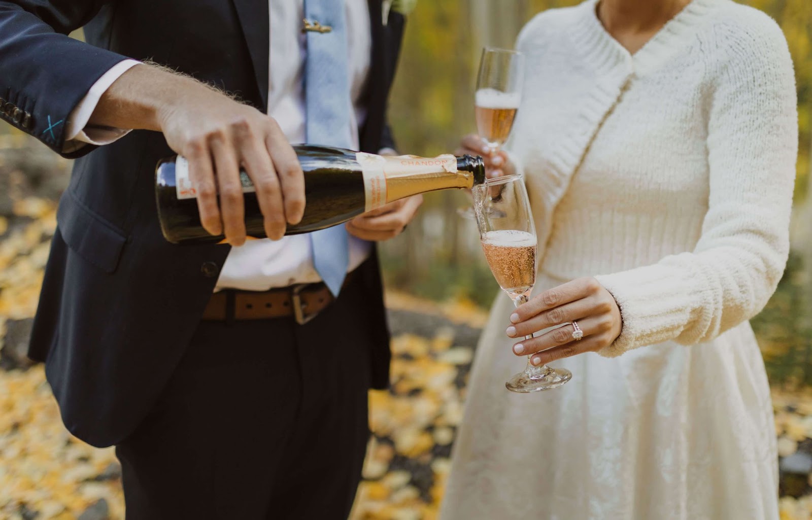 elopement couple pouring champagne - how to make an elopement special