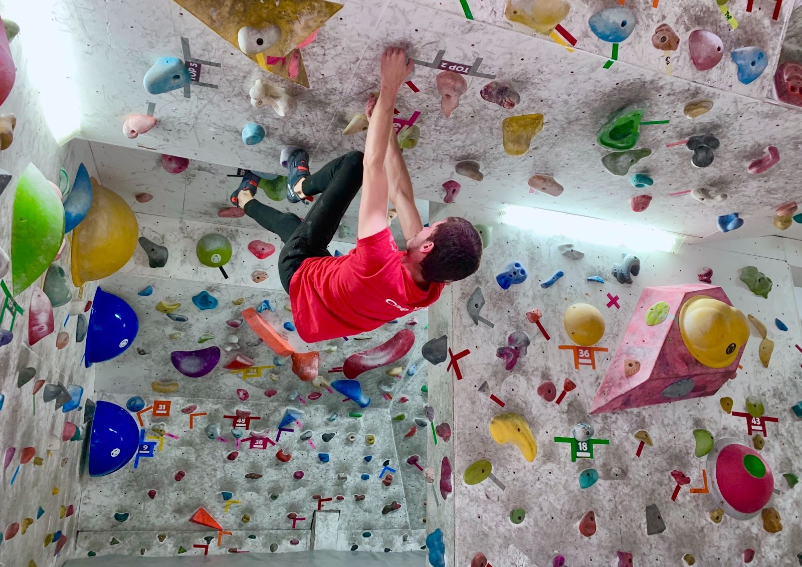 Man climbing at an indoor rock gym