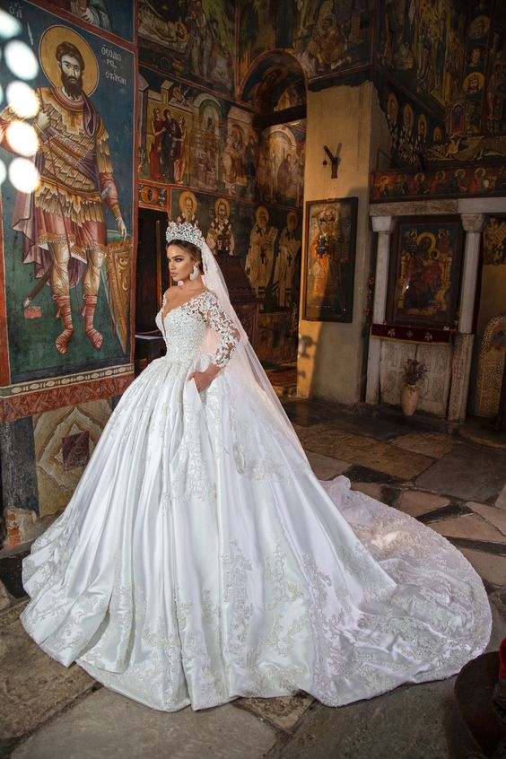 a bride wearing a ball wedding gown with a crown on her head 