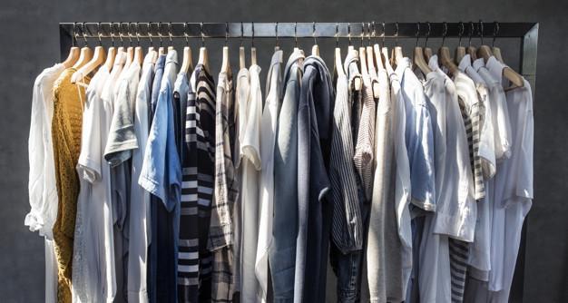 assorted shirts and sweaters in hangers