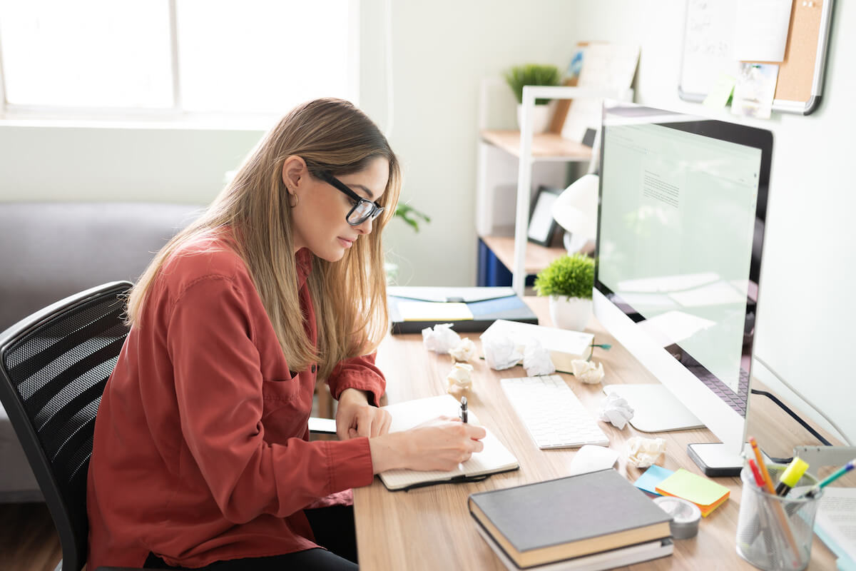 Entrepreneur writing something in her notebook