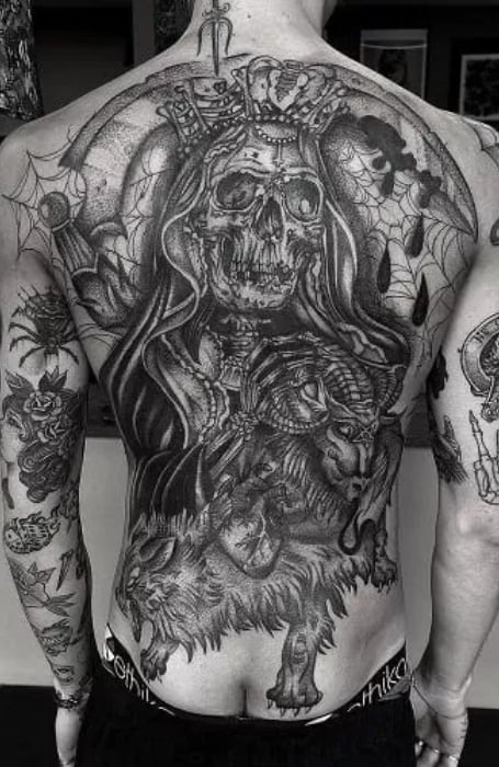 Picture of a guy showing off his grim reaper back tattoo