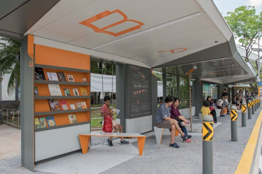 Example of a sheltered bus stop with seating, incorporated into the street-facing facade of a commercial building.