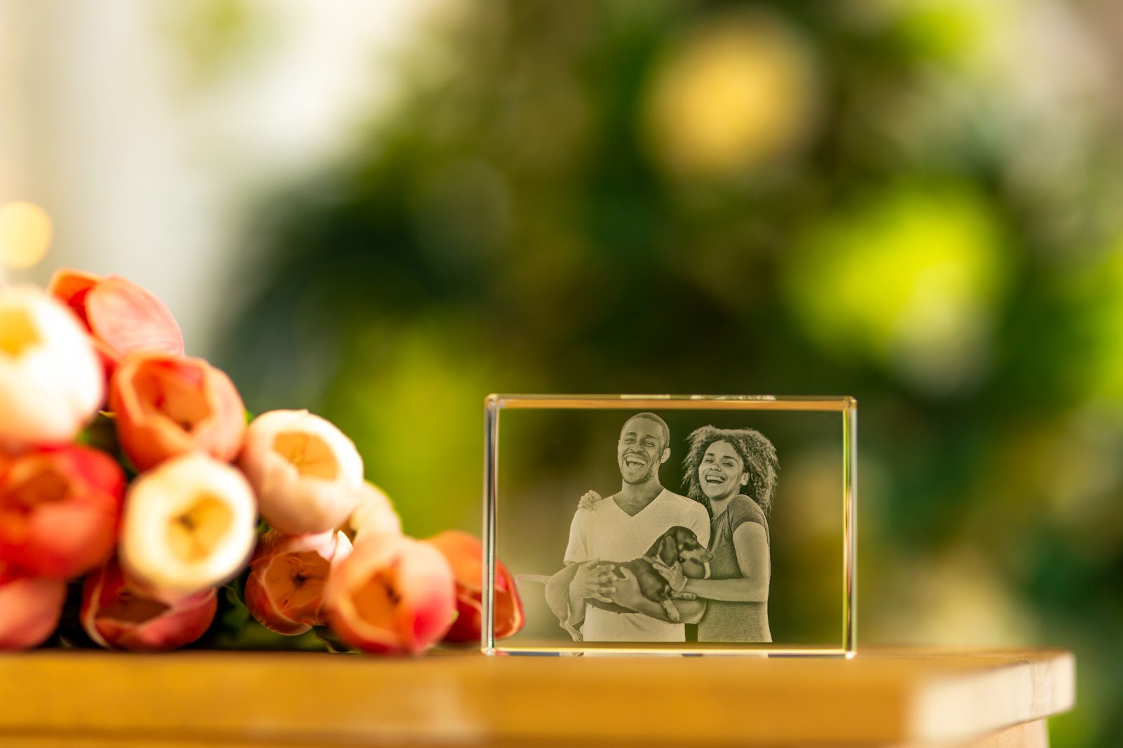 A photo of a happy, fun-loving couple and their dog engraved inside a 3D Crystal.