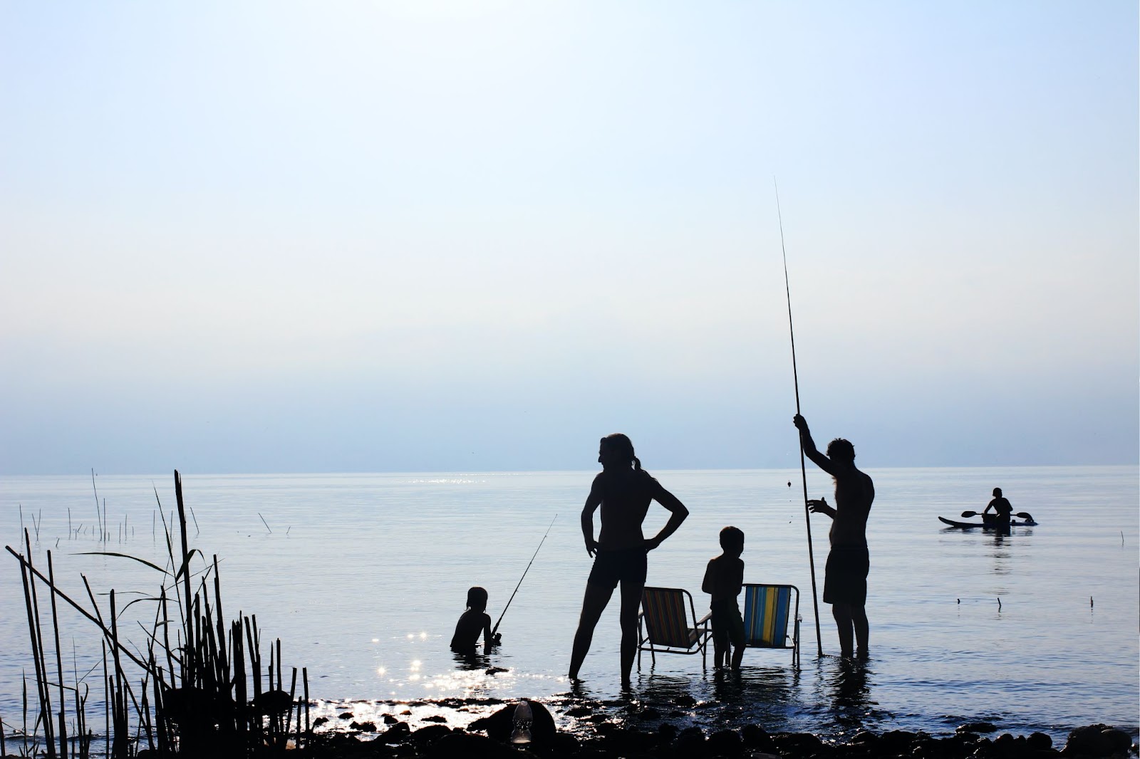 silhouette of a family fishing