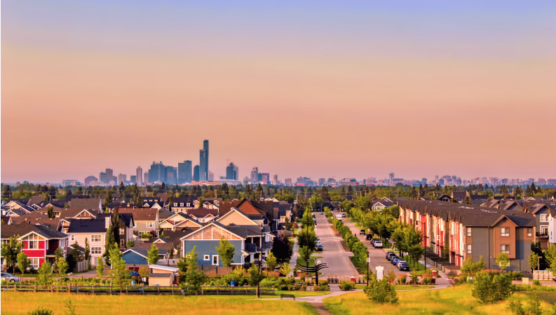 Dusk settles over a lovely residential area in Edmonton, Alberta, with the city skyline in the distance. 