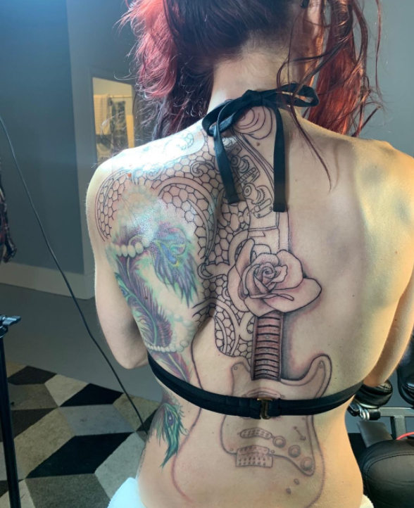 Back Tattoo With A Guitar And A Peacock