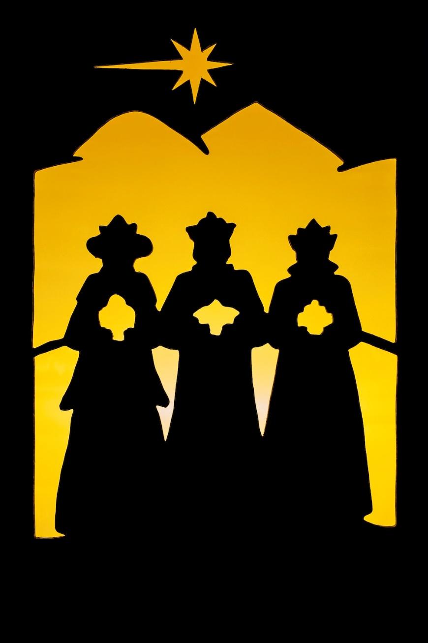 a silhouette of three people standing in front of a star