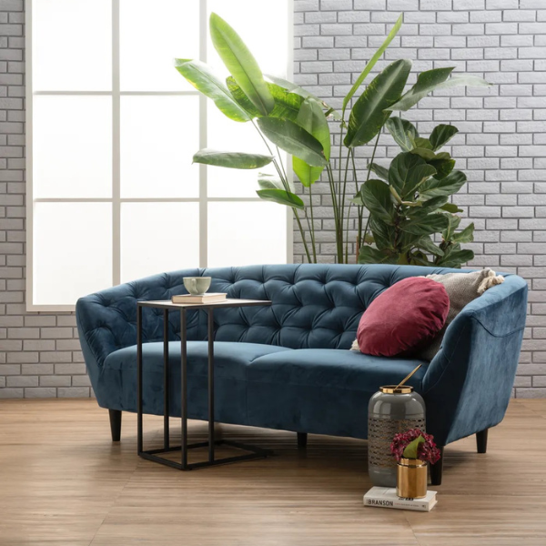 A sophisticated blue velvet 3-seater sofa with tufted backrest, sleek armrests, and solid-wood legs.