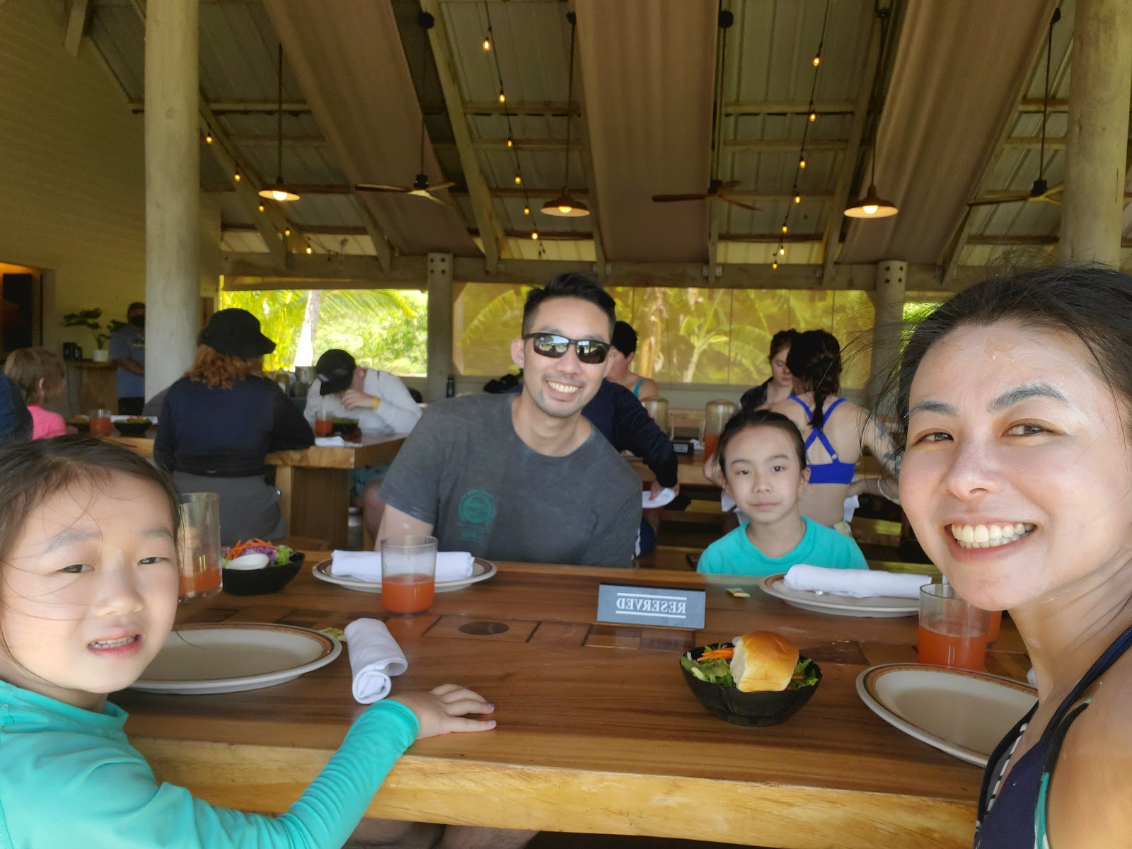 Image of a family of four taking a selfie before lunch.