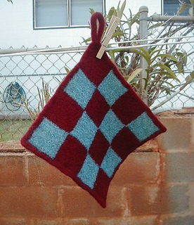 checkered knit pot holder hanging on clothes line