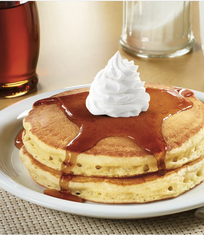 Pancake stack with syrup and whipped cream from Denny's