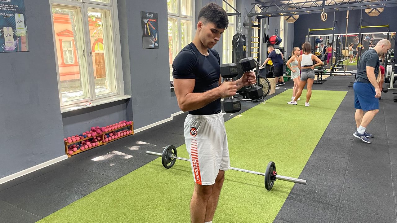 Vanja performs dumbbell hammer curls.