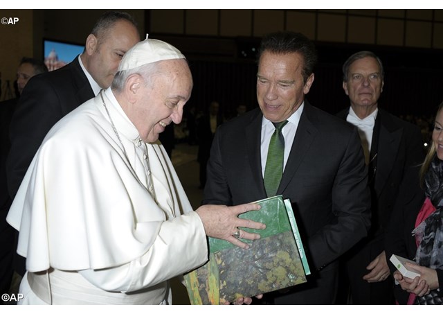 Pope Francis speaks with former governor of California, Arnold Schwarzenegger. - AP