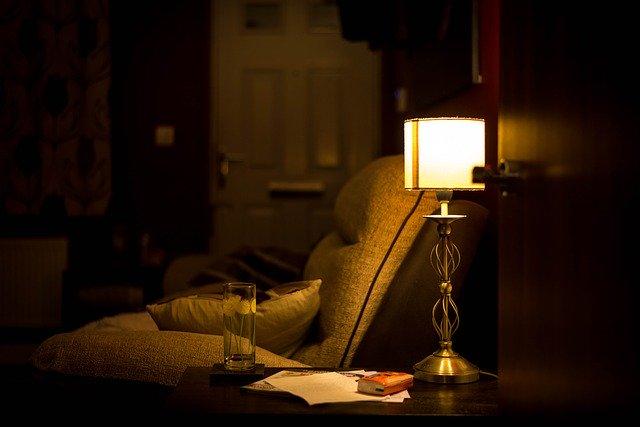A table lamp next to a couch.