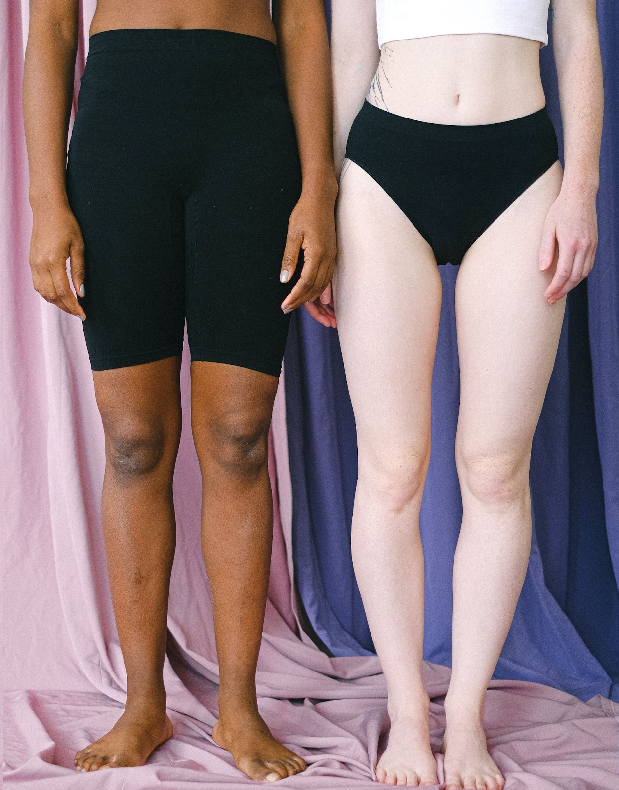 two women standing wearing panty