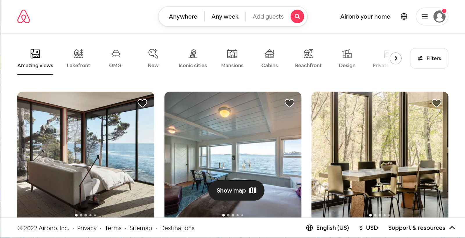 In 2022's home page, there's a banner at the top with icons for various experiences. The Amazing Views option is selected, and there are several listings pictured with beautiful views through the windows.