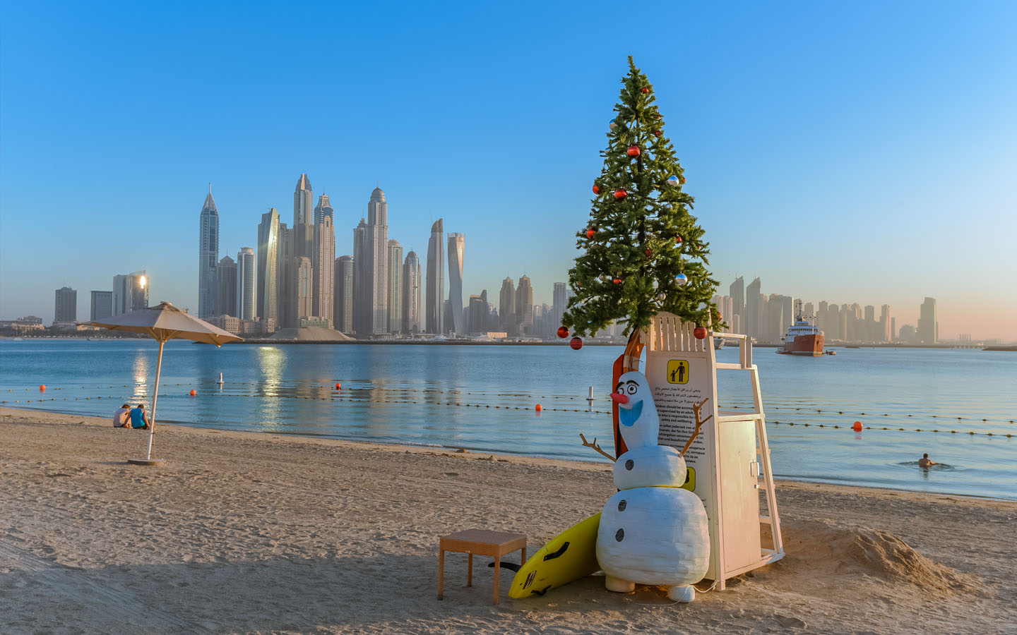 snowman and christmas tree on dubai beach