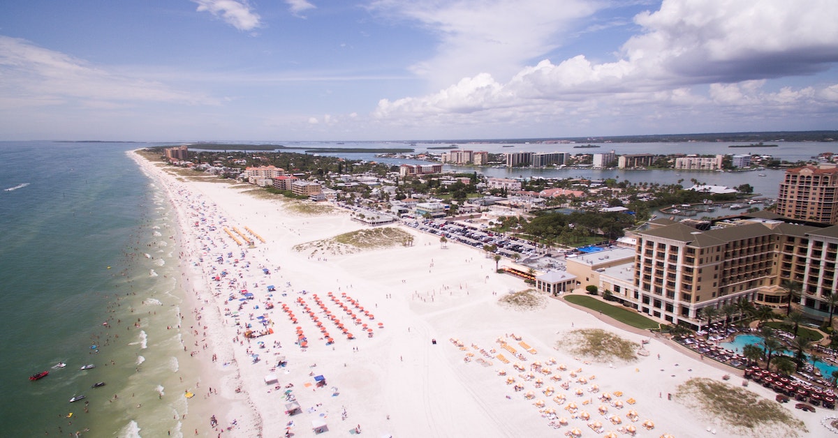 Aerial view of a sandy beach filled with people in Tampa.