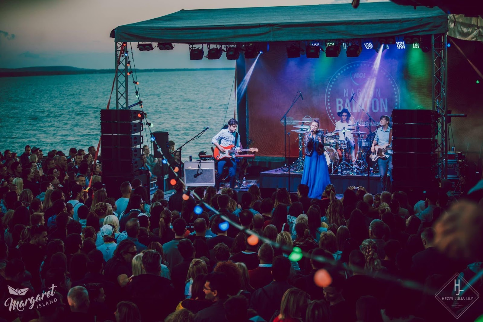 Image may contain: 1 person, on stage, standing, crowd, ocean, sky and outdoor