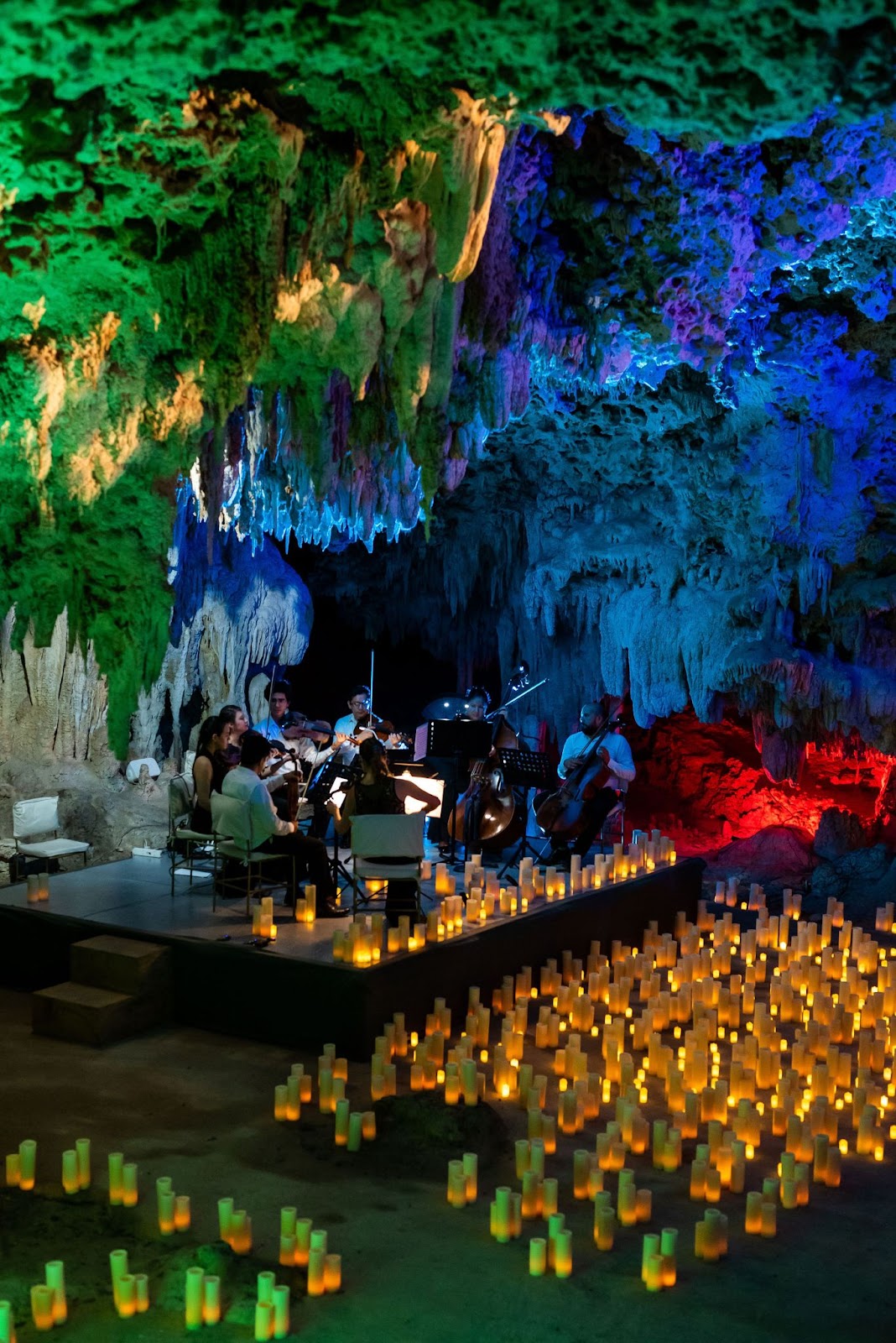 a group of people playing instruments in a cave