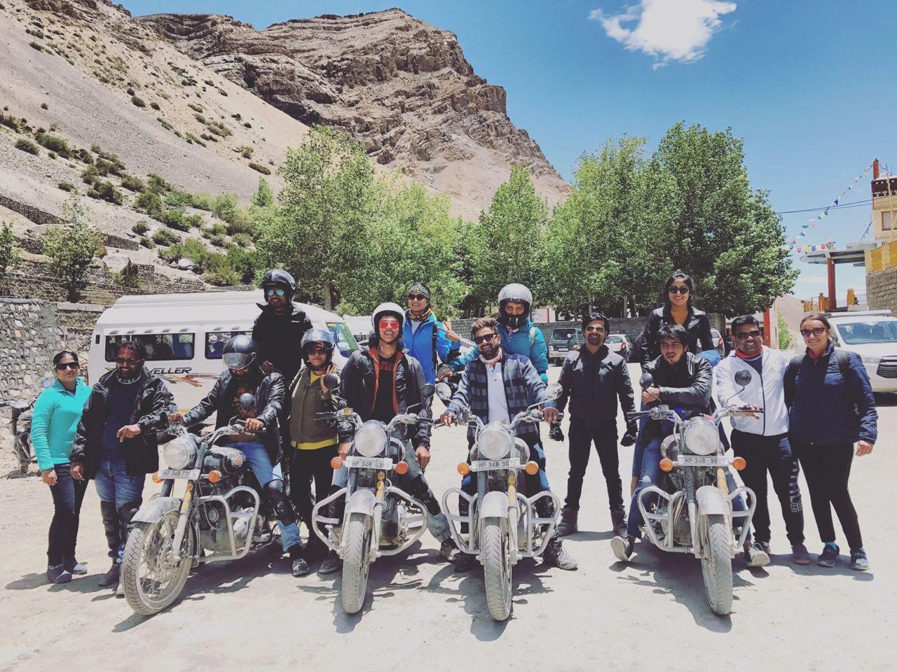 asking strangers to take pictures on vacation on motorcycle trip in Ladakh Himalaya