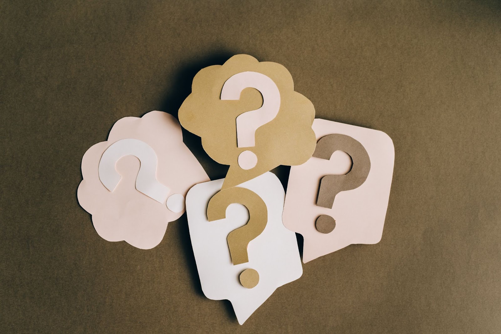 Several cardboard cutouts of question marks