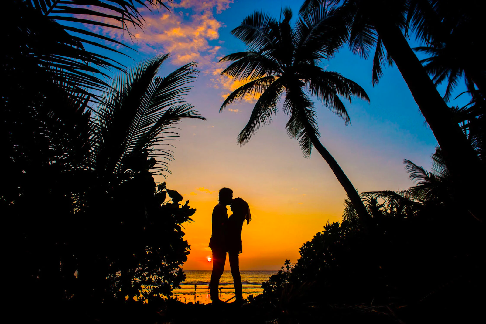 A couple enjoying a summer fling on a beach at sunset