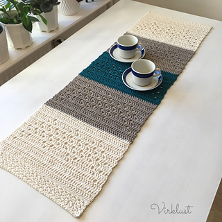 crochet table runner on table with two mugs and saucers