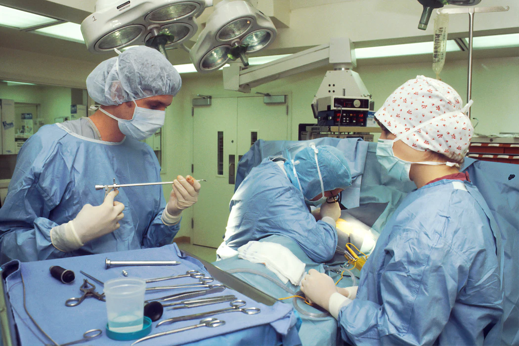 Nurses and doctor in blue scrubs during surgery